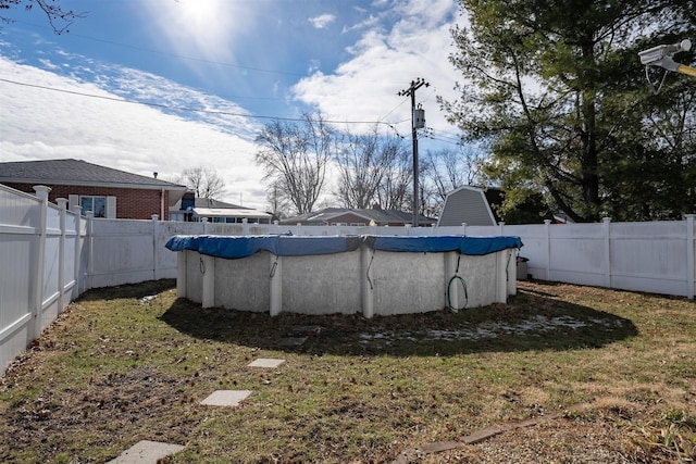 view of pool with a lawn