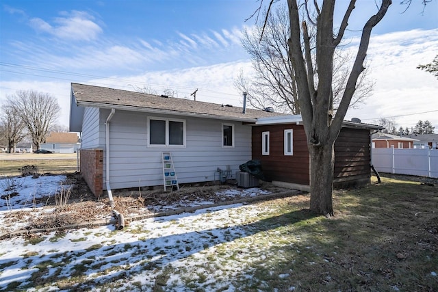 view of snow covered rear of property