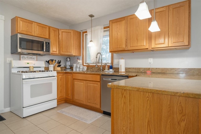 kitchen featuring hanging light fixtures, sink, light tile patterned floors, light stone countertops, and stainless steel appliances