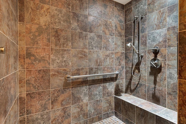 bathroom with tiled shower