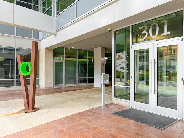 view of exterior entry featuring french doors and a patio