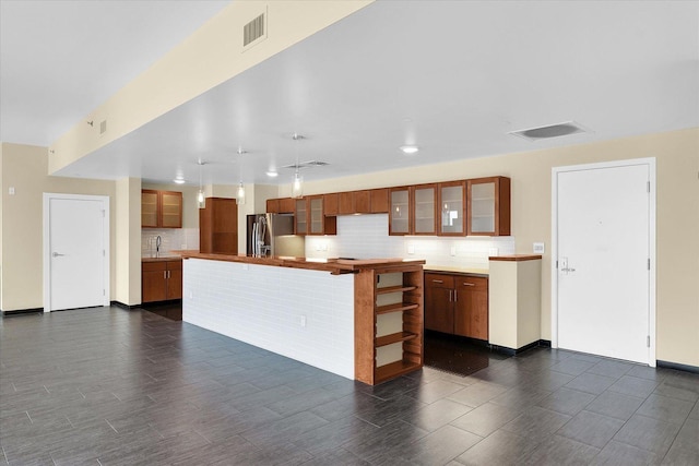 301 N Neil St Unit 808-809, Champaign, IL 61820 - kitchen with stainless steel fridge, decorative backsplash, a center island, glass insert cabinets, and dark wood-style flooring
