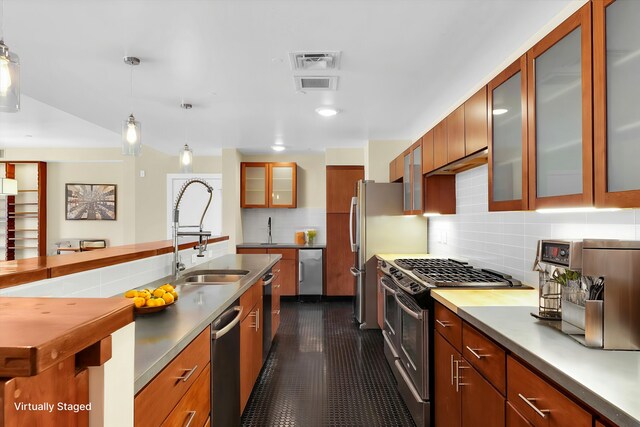 301 N Neil St Unit 808-809, Champaign, IL 61820 - kitchen featuring stainless steel appliances, a sink, decorative backsplash, hanging light fixtures, and glass insert cabinets