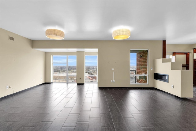 301 N Neil St Unit 808-809, Champaign, IL 61820 - unfurnished living room with wood finish floors and baseboards