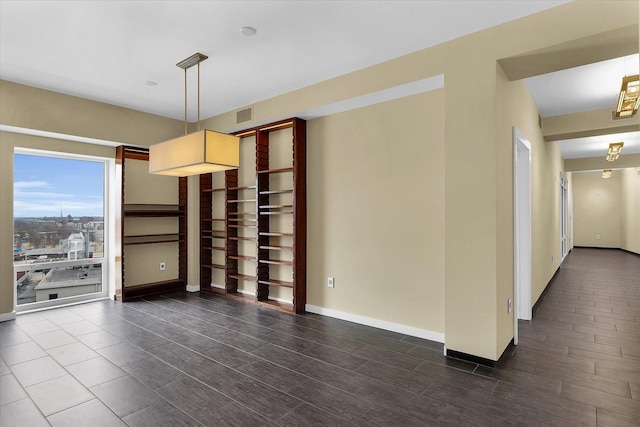 301 N Neil St Unit 808-809, Champaign, IL 61820 - spare room featuring dark wood-style flooring and baseboards