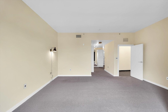 301 N Neil St Unit 808-809, Champaign, IL 61820 - spare room featuring baseboards and dark colored carpet