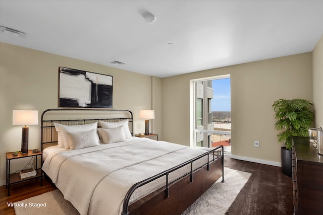 bedroom with dark wood-type flooring