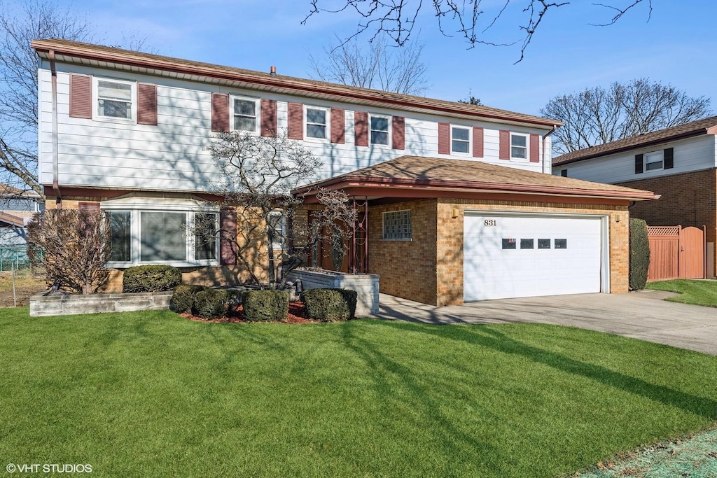 view of front of home with a garage and a front lawn