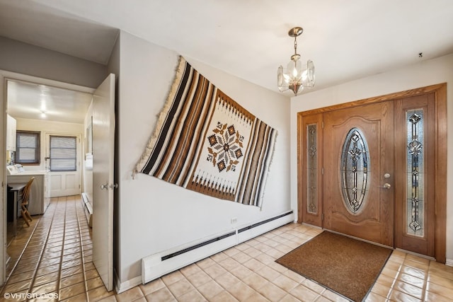 foyer with an inviting chandelier, light tile patterned floors, and a baseboard heating unit