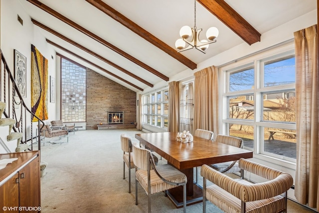 dining space featuring a chandelier, a brick fireplace, carpet floors, high vaulted ceiling, and beam ceiling