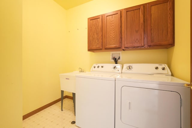 washroom featuring cabinets and independent washer and dryer