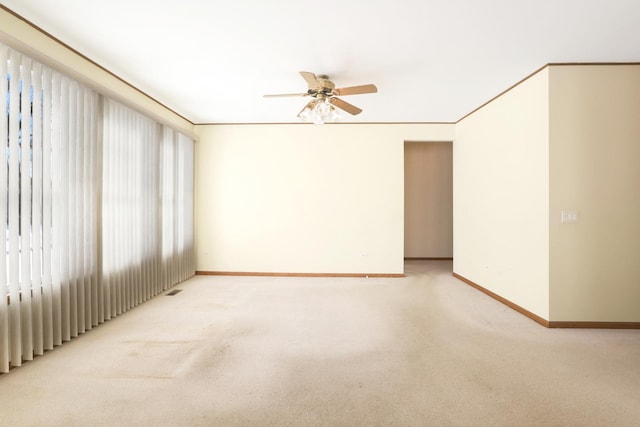 carpeted empty room featuring ceiling fan