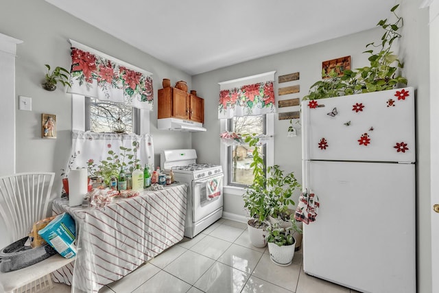 kitchen with white appliances and light tile patterned flooring