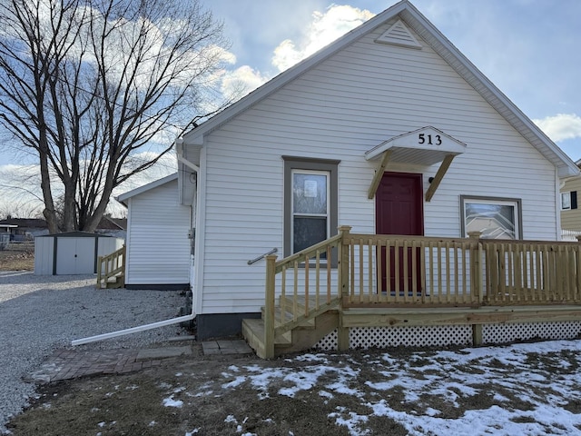 bungalow-style house featuring a storage unit