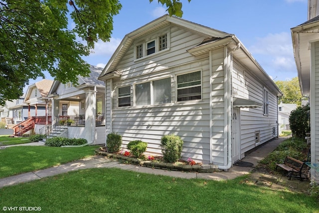 bungalow-style home with a porch and a front yard