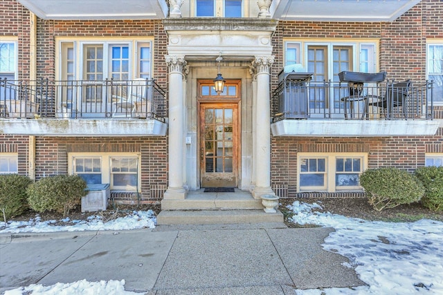 view of snow covered property entrance