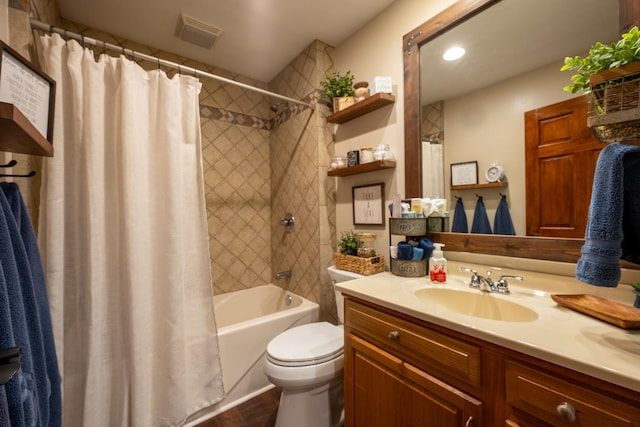 full bathroom with shower / bath combo, vanity, and toilet