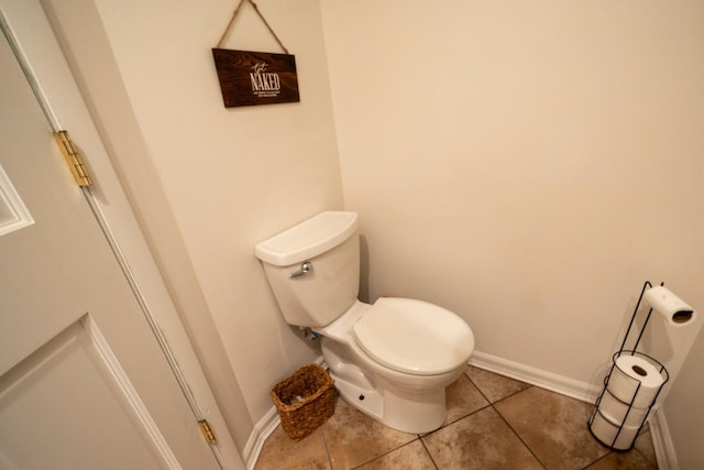 bathroom with toilet and tile patterned floors