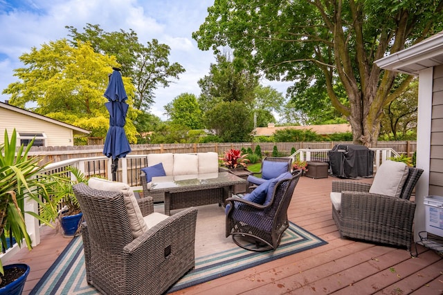 wooden terrace featuring a grill and outdoor lounge area