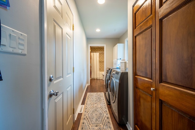 laundry room featuring cabinets, washing machine and dryer, and dark hardwood / wood-style floors