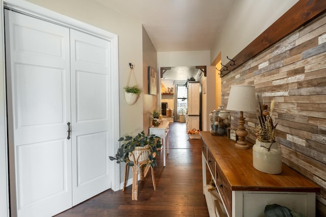 hall featuring wood walls and dark hardwood / wood-style floors