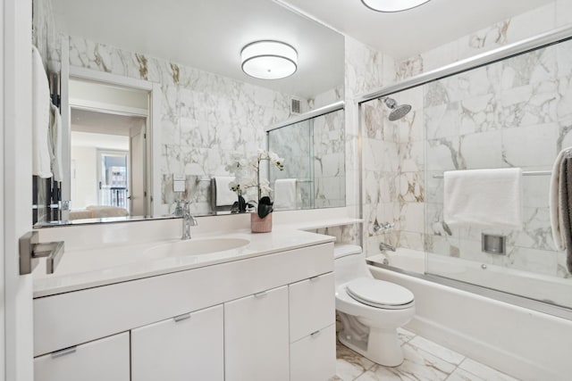 full bathroom featuring toilet, enclosed tub / shower combo, and vanity