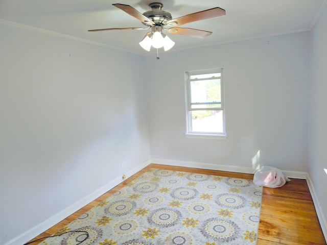 unfurnished room with light wood-style flooring, baseboards, and crown molding