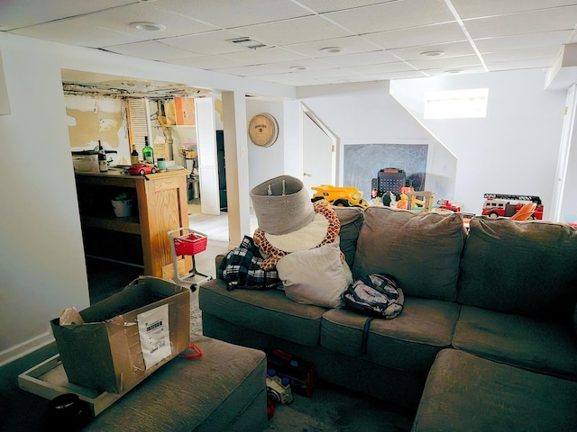 living room featuring visible vents and a drop ceiling