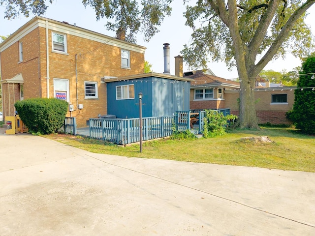 exterior space featuring brick siding and a yard