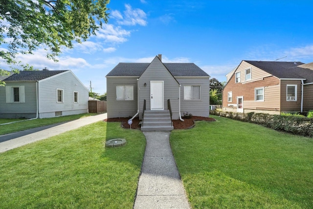 bungalow-style home featuring a front yard and cooling unit