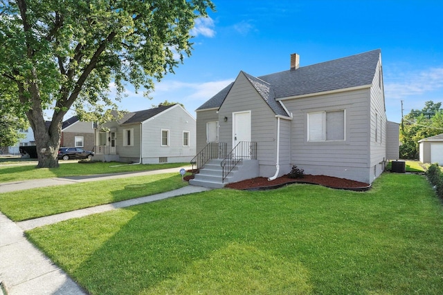 view of front of home with central AC and a front yard