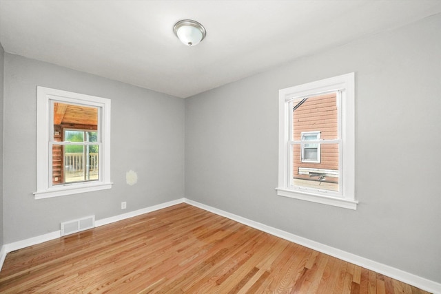 unfurnished room with hardwood / wood-style flooring