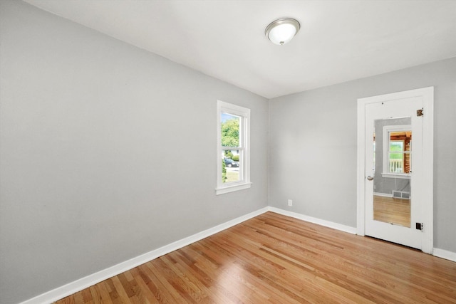 spare room with hardwood / wood-style floors