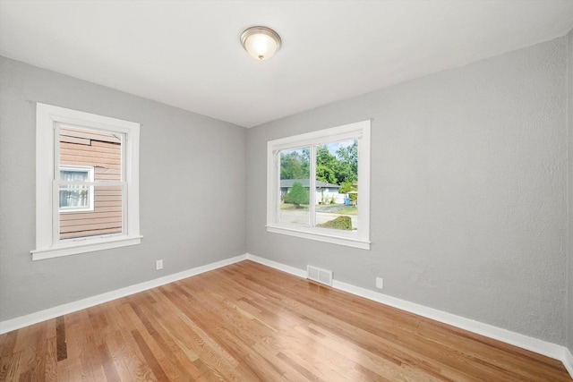 unfurnished room with wood-type flooring