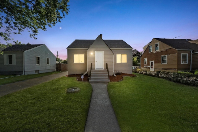 bungalow-style house with a lawn