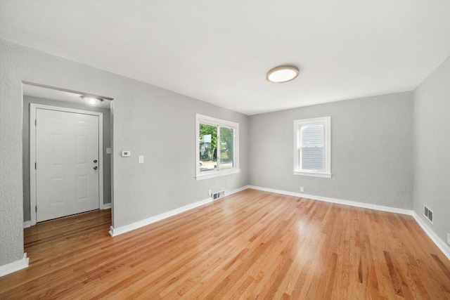 spare room featuring light hardwood / wood-style floors