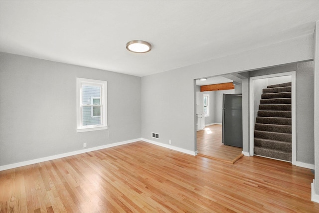 empty room with light hardwood / wood-style floors