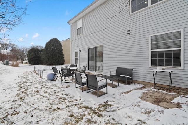 view of snow covered back of property