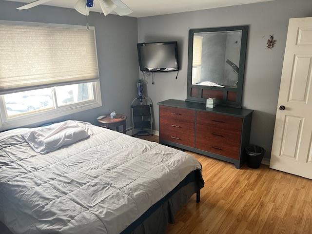 bedroom with light wood-type flooring and ceiling fan