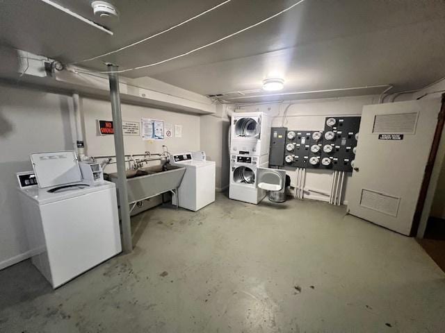 basement with stacked washer and dryer, washing machine and dryer, and sink