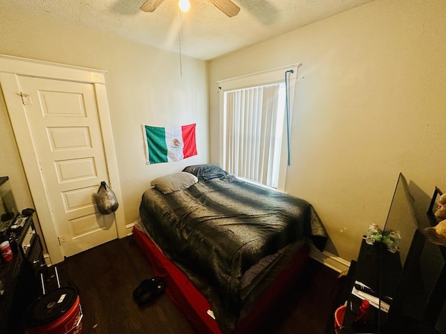 bedroom featuring ceiling fan, hardwood / wood-style floors, and a textured ceiling