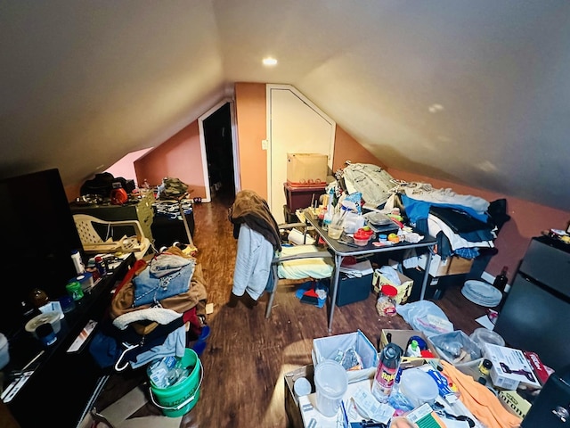 additional living space with vaulted ceiling and dark hardwood / wood-style floors