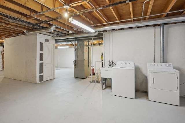 basement with washer and dryer and heating unit