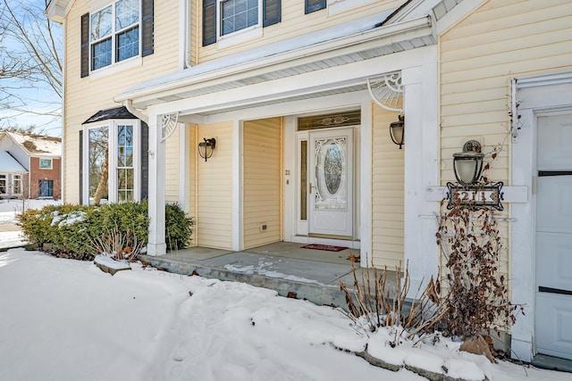 view of snow covered property entrance