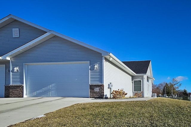 view of home's exterior with a lawn and a garage