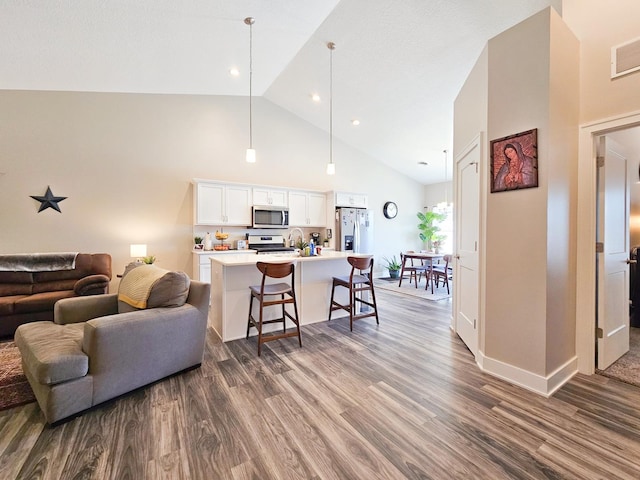 living room with high vaulted ceiling and dark hardwood / wood-style floors