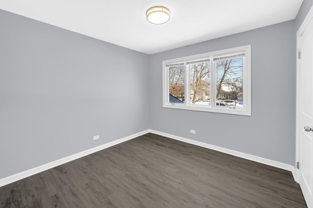 spare room with dark hardwood / wood-style floors