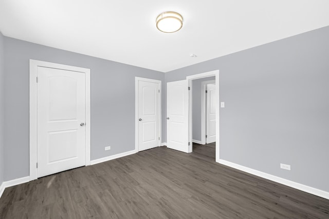 unfurnished bedroom featuring dark hardwood / wood-style flooring