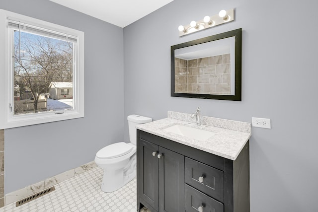 bathroom featuring toilet, tile patterned floors, and vanity