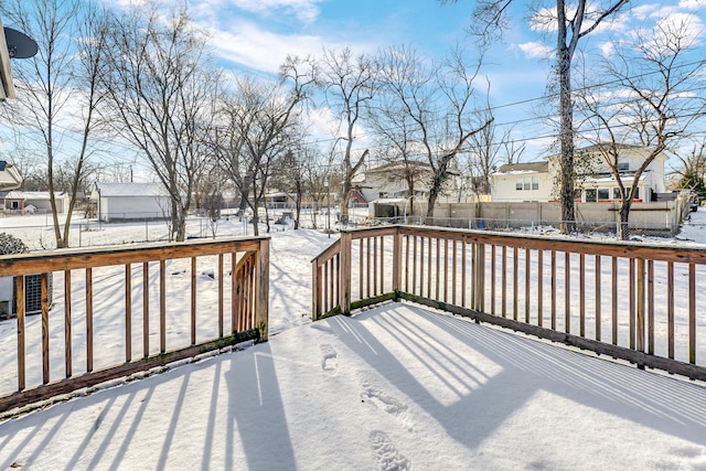 snow covered deck featuring cooling unit